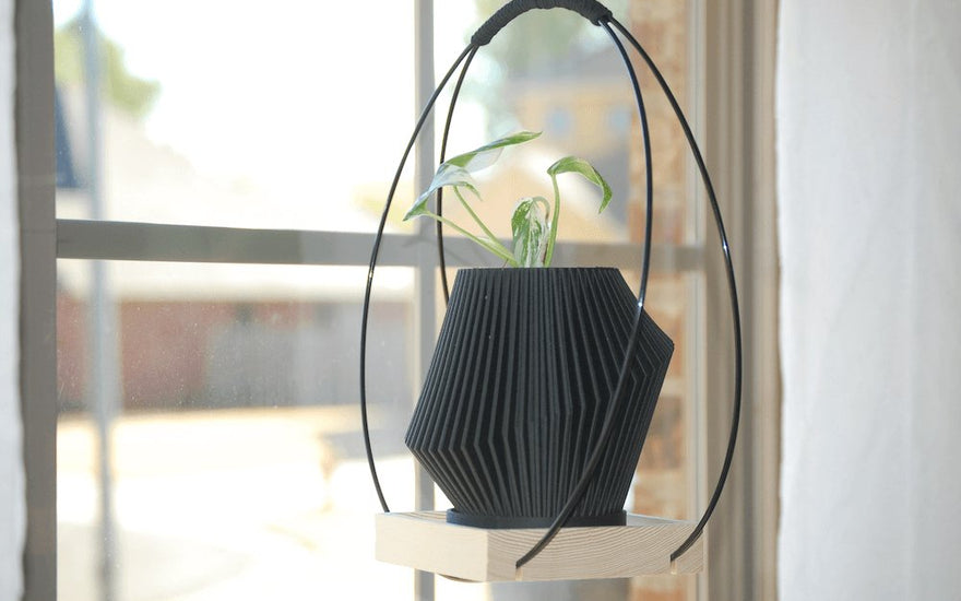 Black modern hanging plant holder.