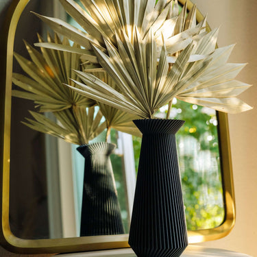 Banda black vase with dried palms.