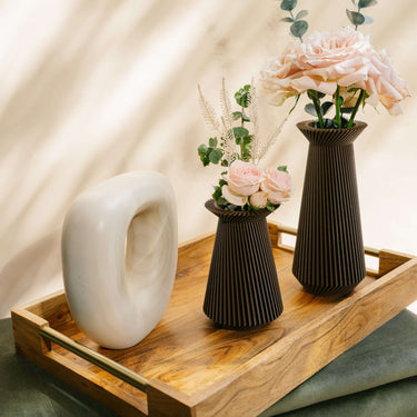 Two BANDA brown vases with flowers and accent decor.