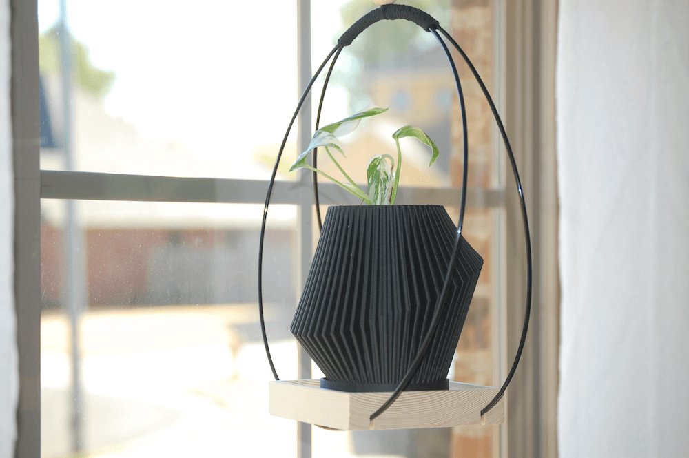 Black modern hanging plant holder.