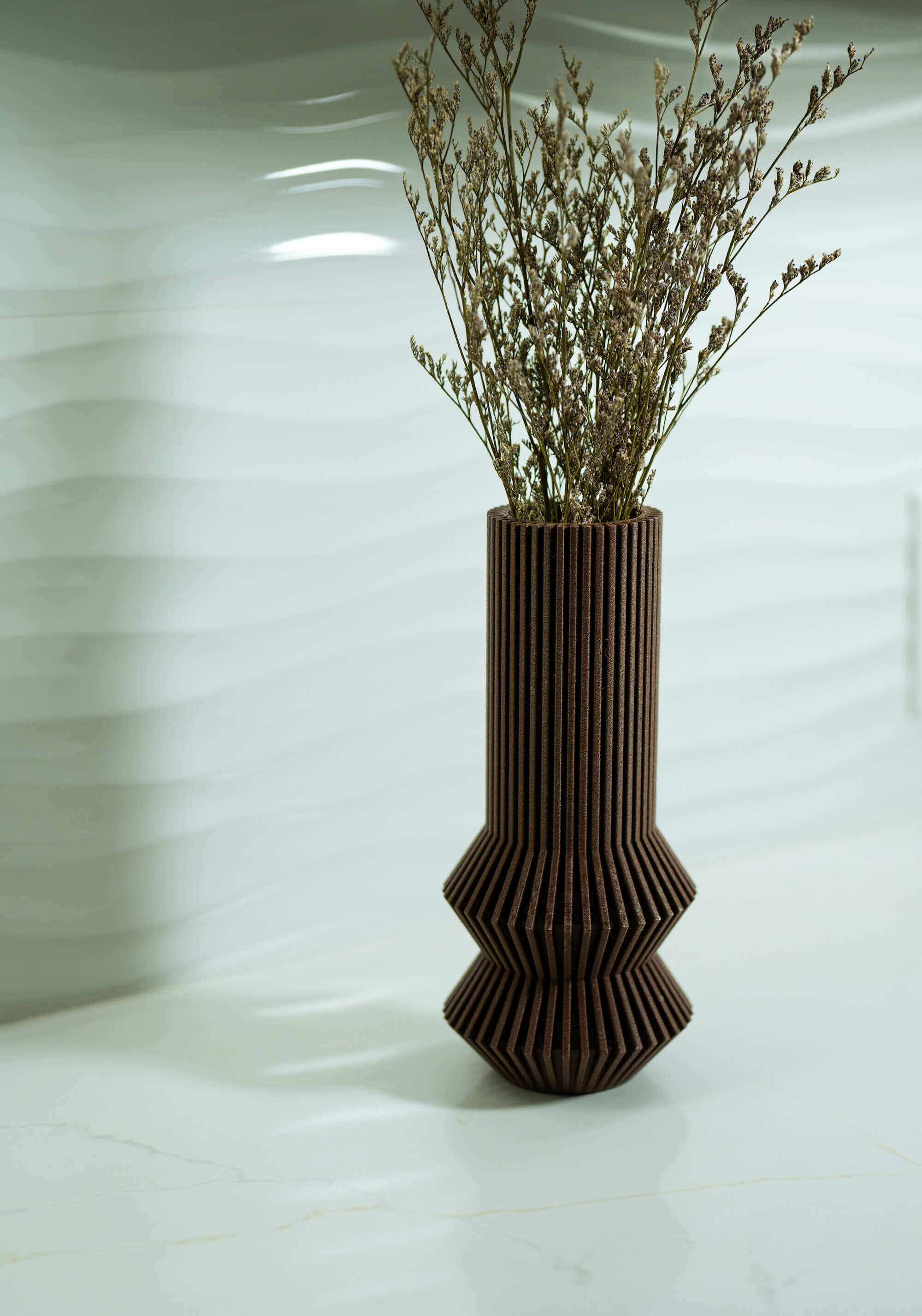 A mid century modern vase / modernist vase by Woodland Pulse. This is a brown vase on a kitchen countertop with pampas grass.
