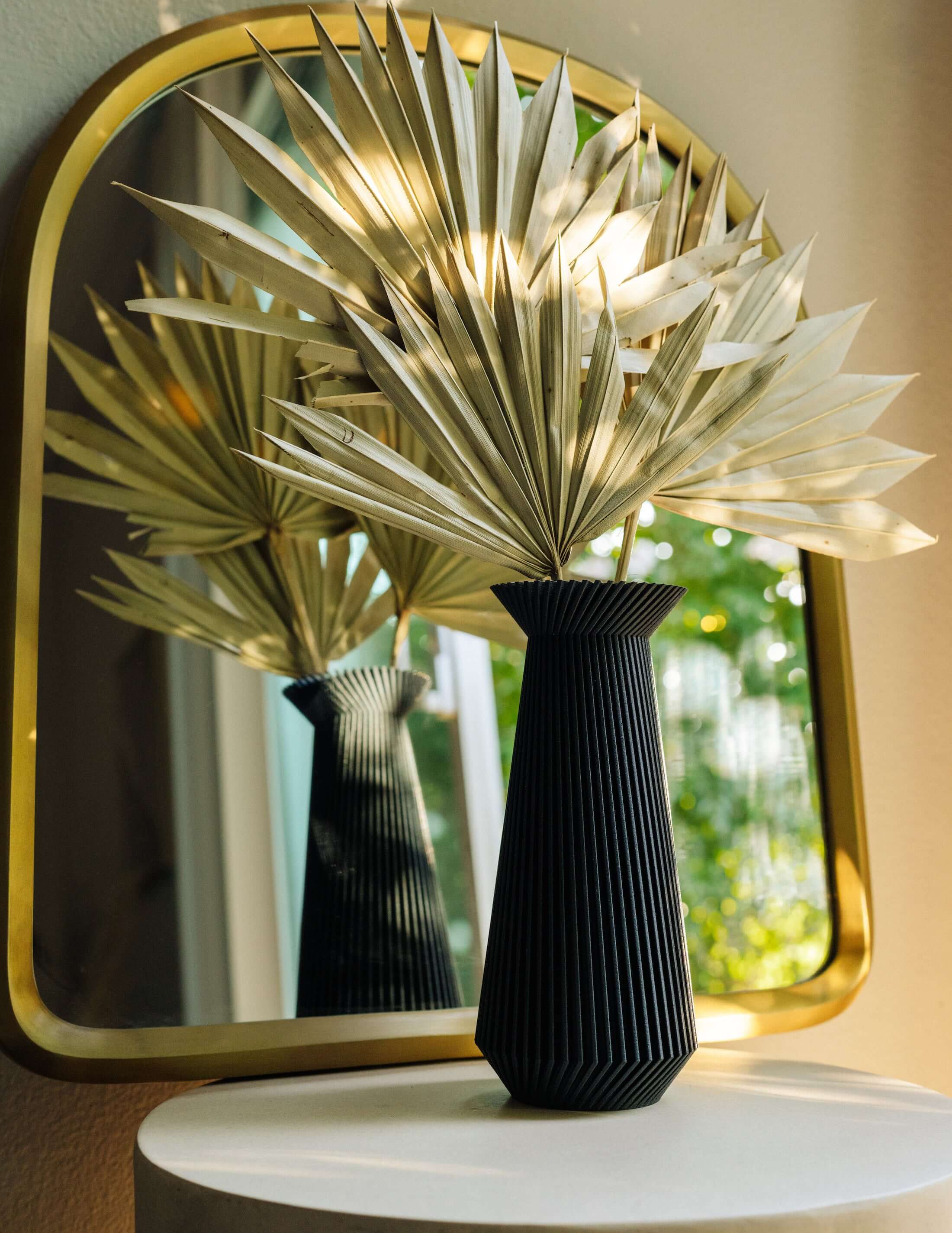 Banda black vase with dried palms.