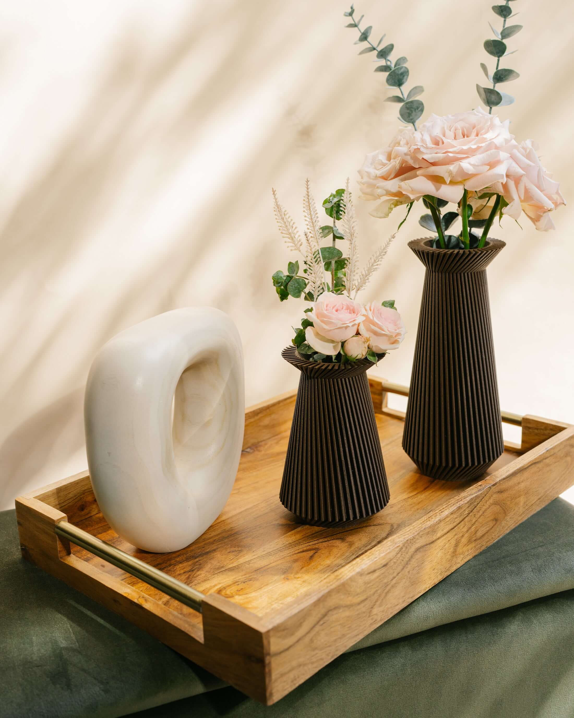 Two BANDA brown vases with flowers and accent decor.