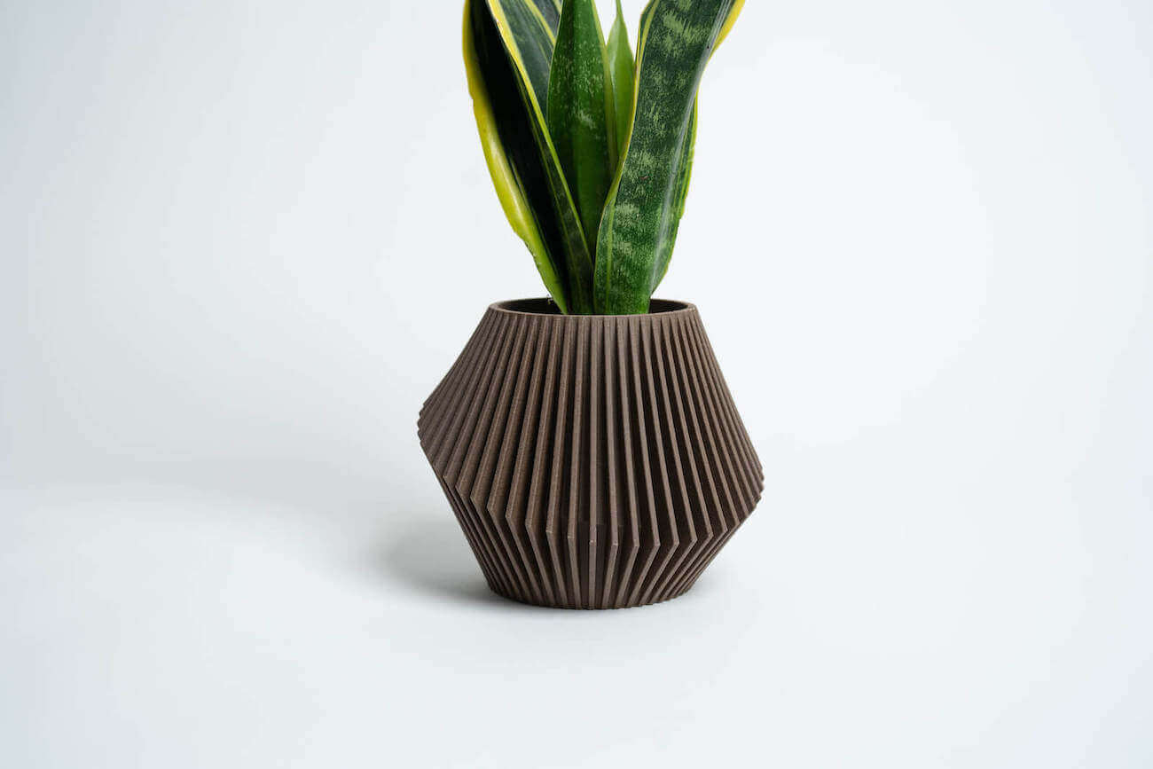 A unique planter in brown by Woodland Pulse. This is a wooden decor planter.