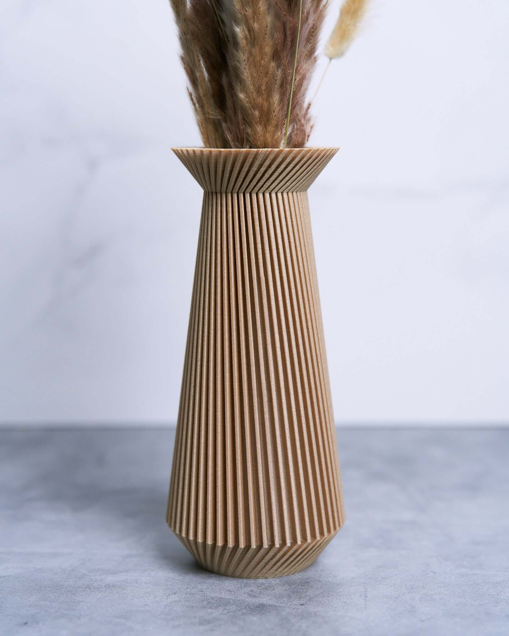A close up photo of a modernist vase / beige grass with pampas grass. This is a boho vase by Woodland Pulse.