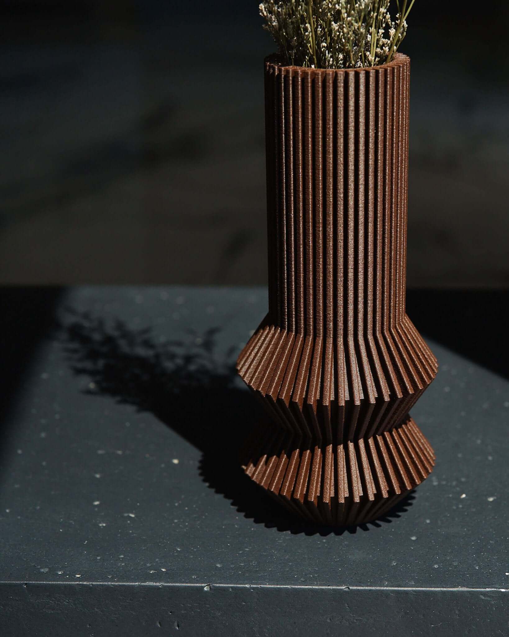 A close up shot of a unique vase by Woodland Pulse. This is a textured vase / brown vase with an abstract vase design.
