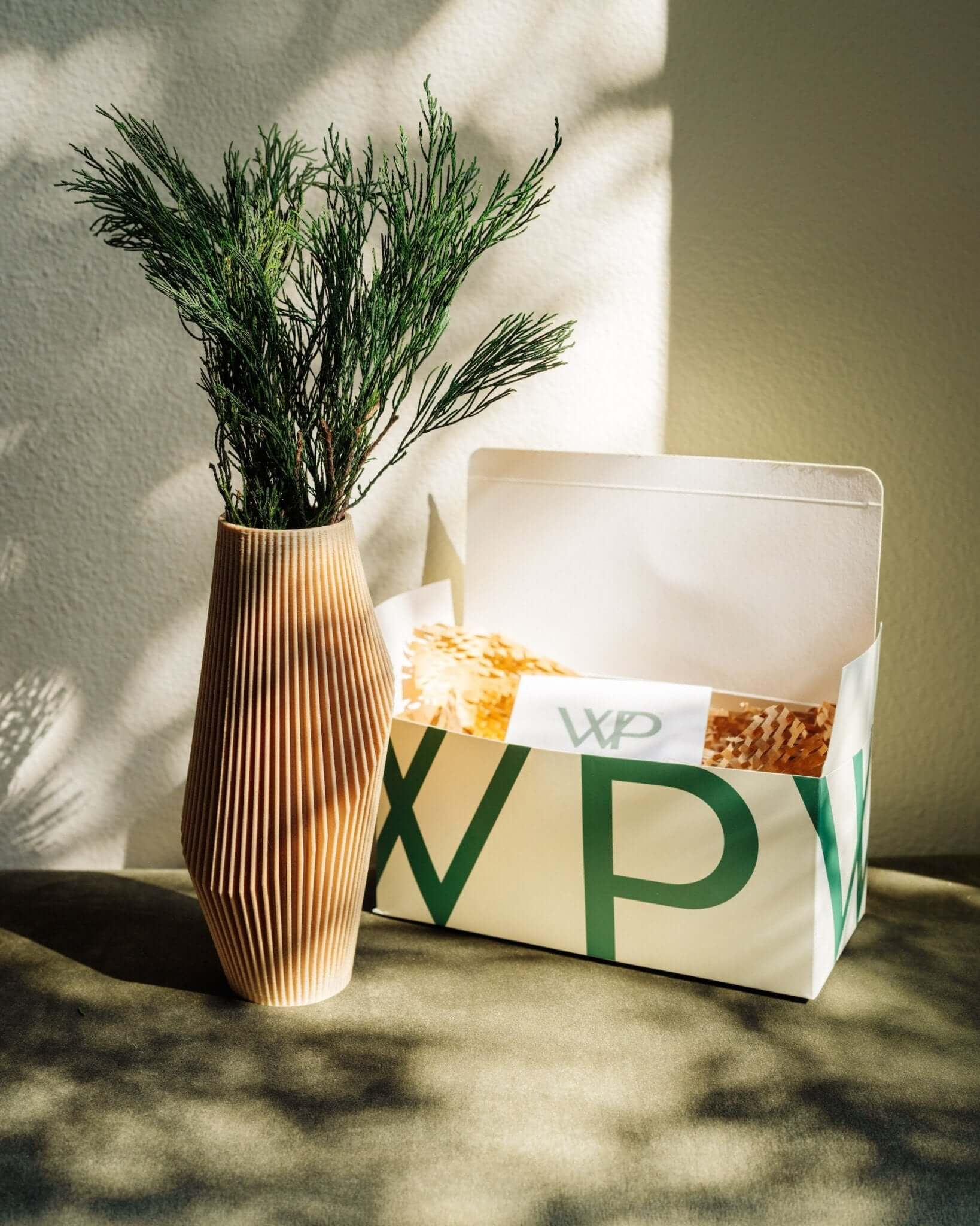 NOVA beige vase with pine decor and decorative packaging.
