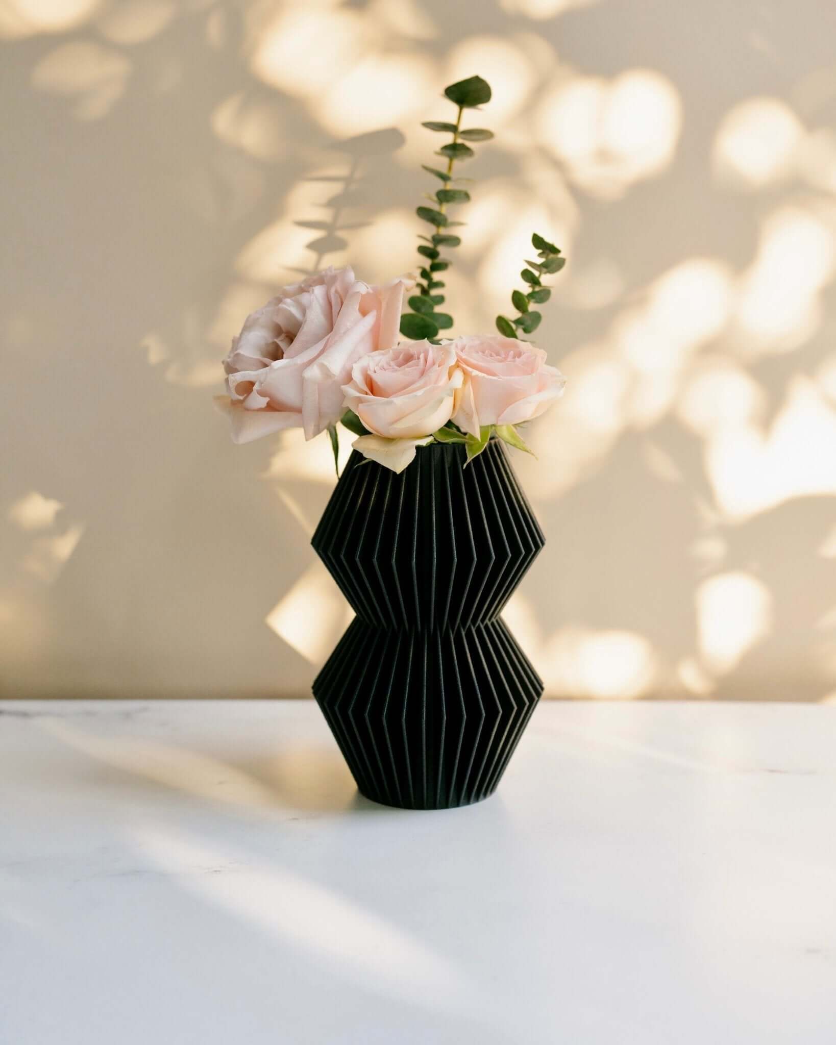 Black geometric vase by Woodland Pulse.