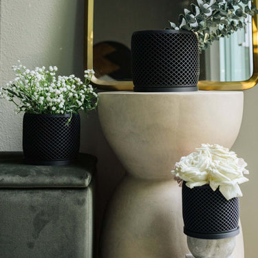 Three vision black planter pots with roses, floral, and eucalyptus.